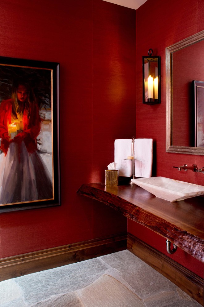 На фото: туалет в современном стиле с настольной раковиной, столешницей из дерева, красными стенами и красной столешницей