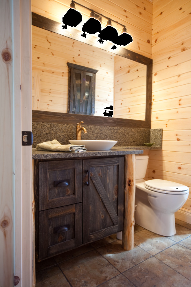 Inspiration for a mid-sized rustic ceramic tile powder room remodel in Other with furniture-like cabinets, distressed cabinets, a one-piece toilet, beige walls, a vessel sink and granite countertops