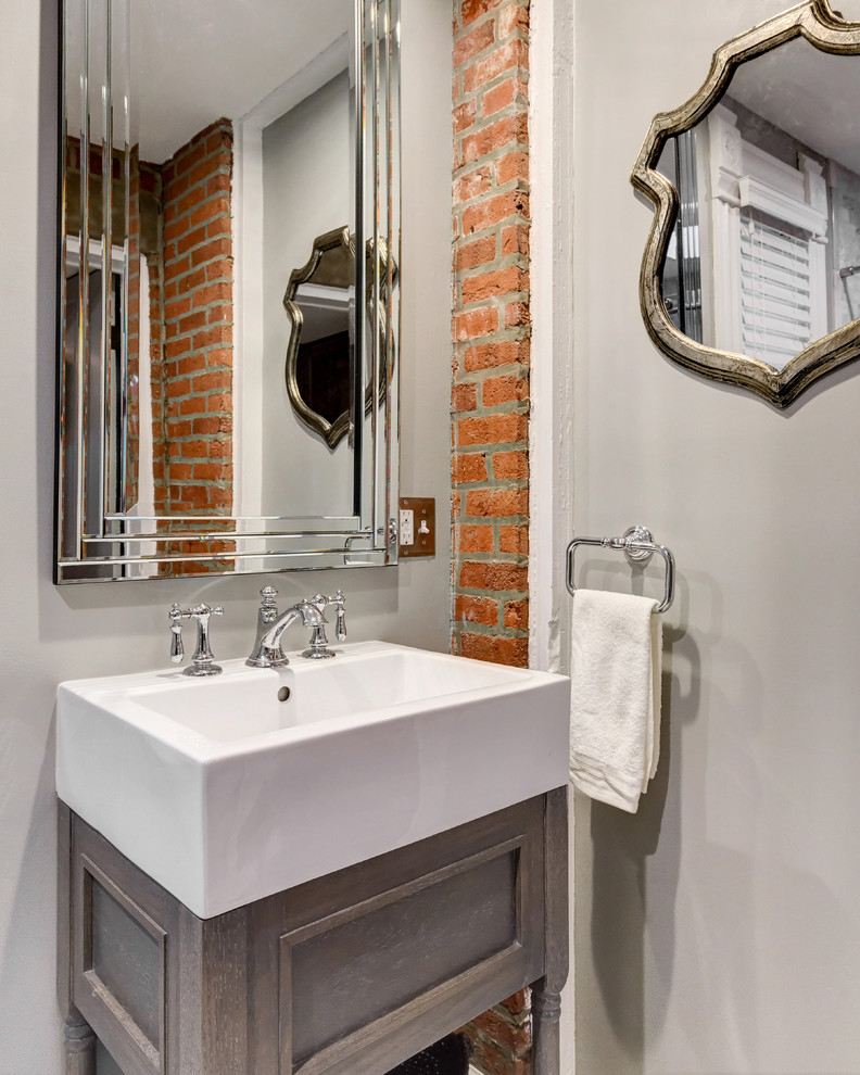 Medium sized traditional cloakroom in Los Angeles with freestanding cabinets, grey cabinets, grey walls and a vessel sink.