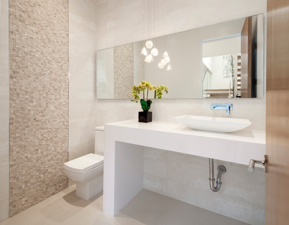 Photo of a modern cloakroom in Los Angeles with beige tiles, a vessel sink, beige floors and white worktops.
