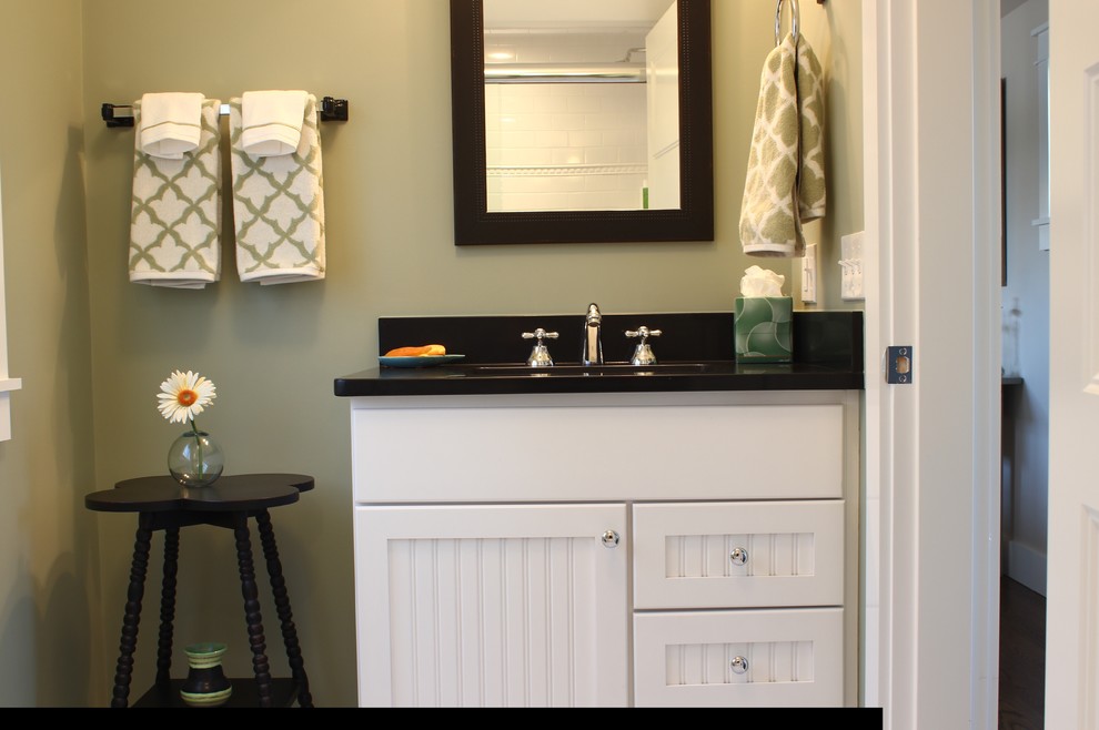 Design ideas for a medium sized farmhouse cloakroom in Providence with shaker cabinets, white cabinets, black tiles, porcelain tiles, green walls, a submerged sink and solid surface worktops.