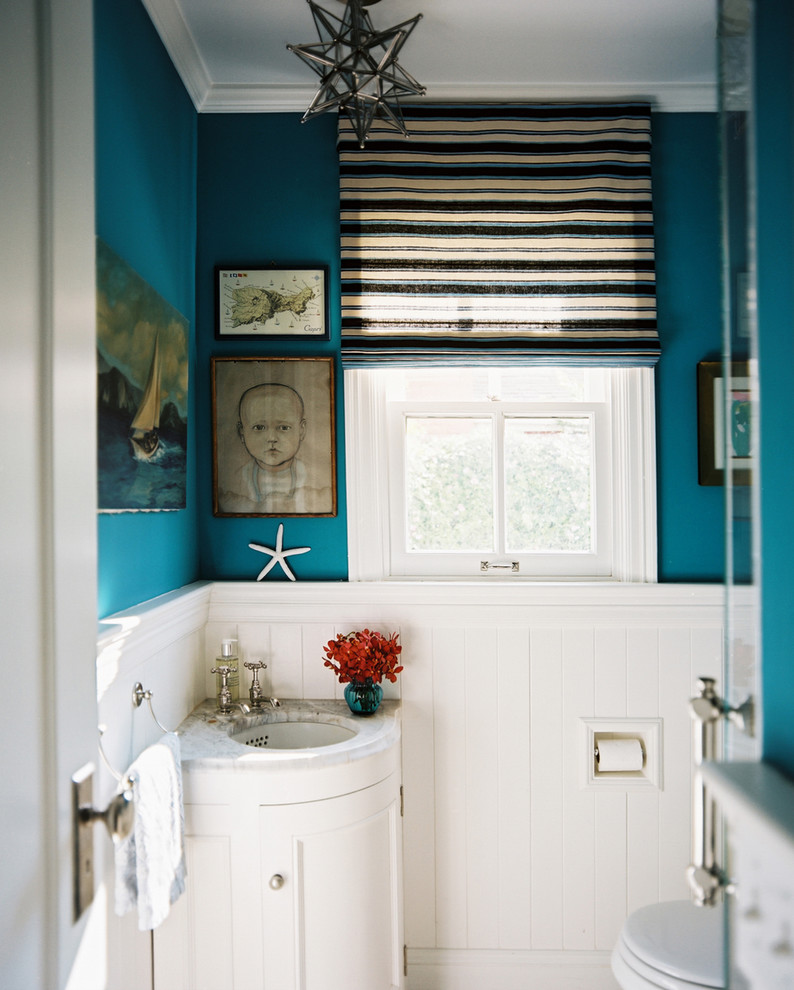 Example of an eclectic powder room design in San Francisco with an undermount sink, recessed-panel cabinets and white cabinets