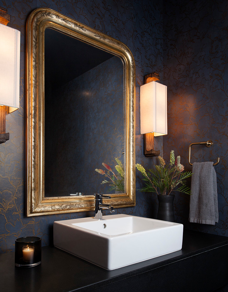 Example of a trendy powder room design in Austin with multicolored walls, a vessel sink and black countertops