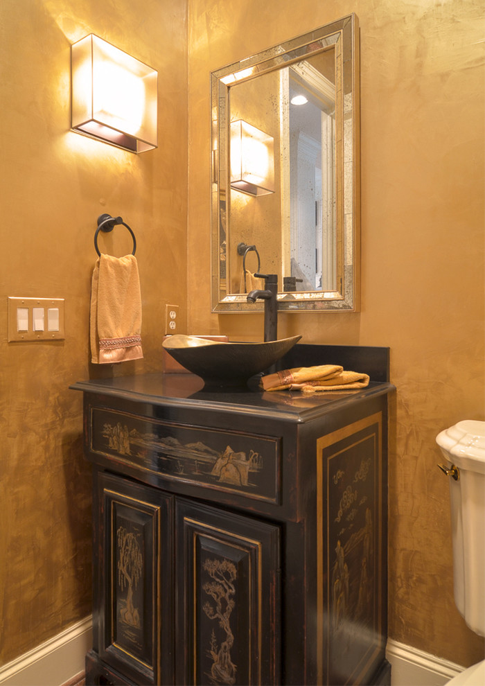 This is an example of a small traditional cloakroom in Dallas with stone tiles, yellow walls, marble flooring, a vessel sink, granite worktops, distressed cabinets and freestanding cabinets.