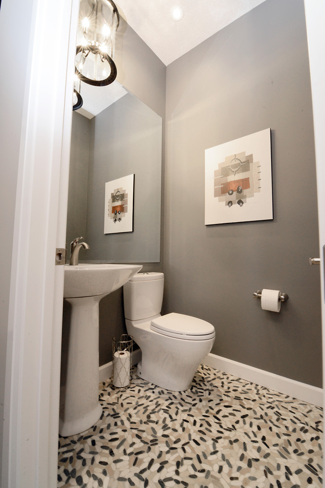 Photo of a small contemporary cloakroom in Edmonton with a one-piece toilet, beige tiles, brown tiles, grey tiles, multi-coloured tiles, mosaic tiles, grey walls, mosaic tile flooring and a pedestal sink.