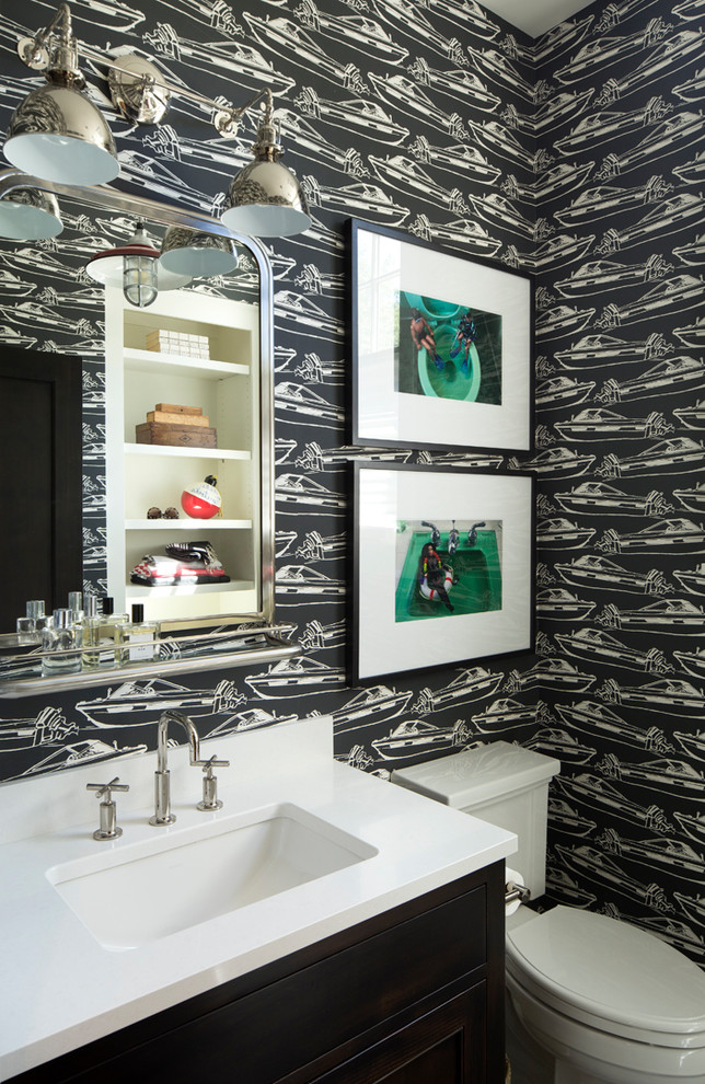 Inspiration for a beach style cloakroom in Minneapolis with flat-panel cabinets, black cabinets, a two-piece toilet, black walls, a submerged sink and white worktops.