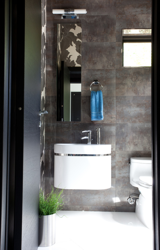 Photo of a contemporary cloakroom in New York with a wall-mounted sink, a one-piece toilet and brown tiles.