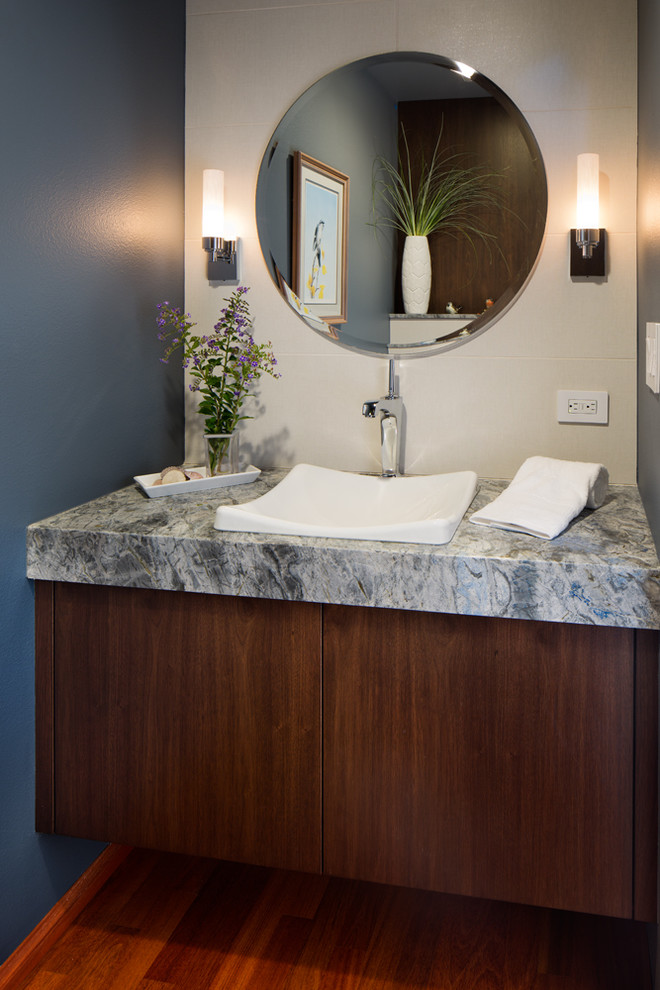 Inspiration pour un petit WC et toilettes traditionnel en bois foncé avec un placard à porte plane, un sol en bois brun, une vasque, un plan de toilette en granite, WC séparés et un mur bleu.