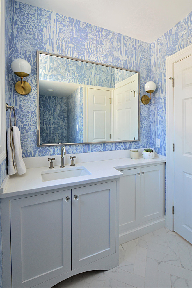 Example of a small transitional porcelain tile and white floor powder room design in Boston with shaker cabinets, white cabinets, blue walls, an undermount sink and quartz countertops