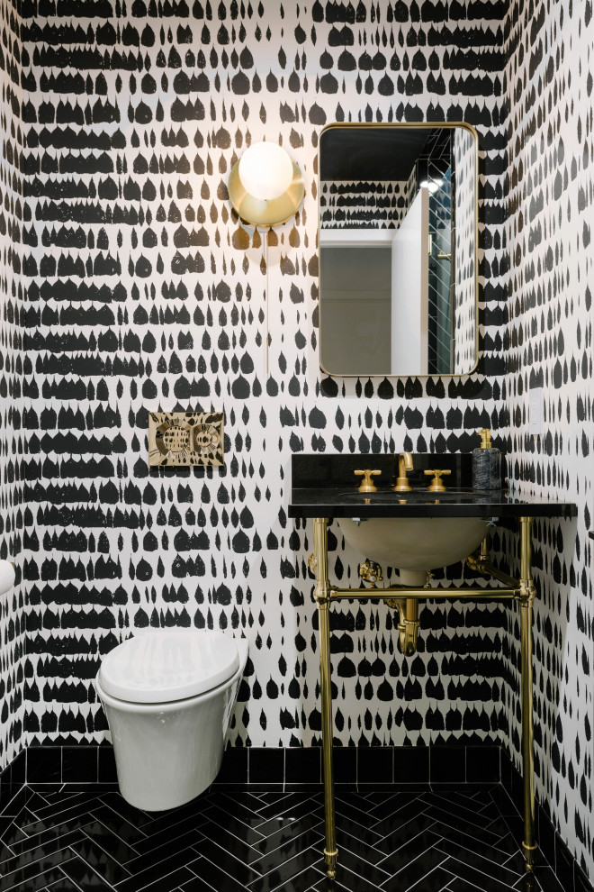 Example of a trendy ceramic tile, black floor and wallpaper powder room design in New York with black cabinets and a console sink