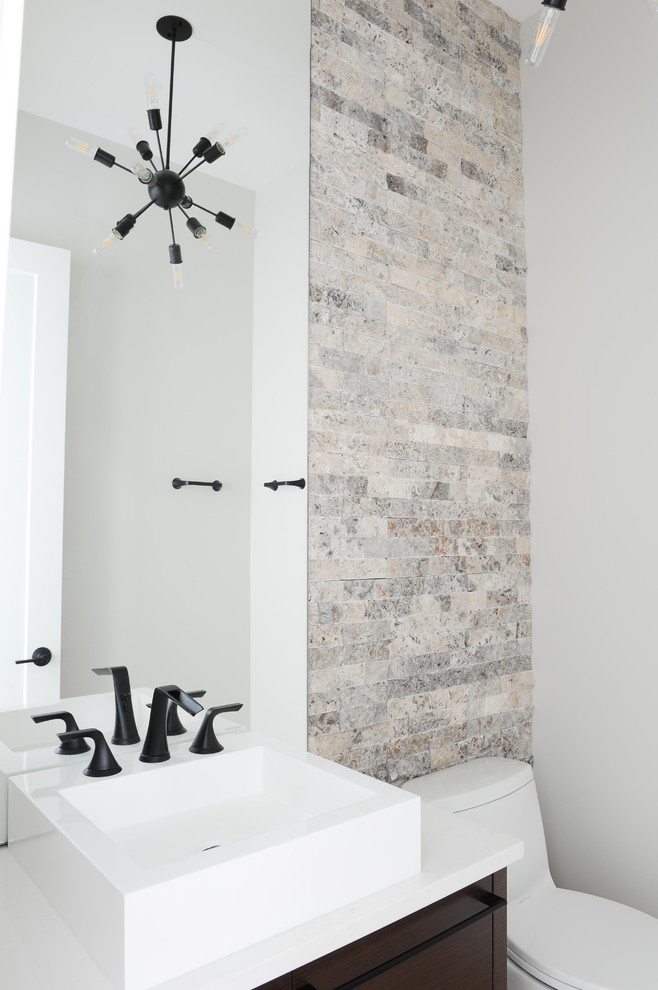 Trendy white tile terra-cotta tile and gray floor powder room photo in Other with flat-panel cabinets, brown cabinets, white walls, solid surface countertops and a vessel sink