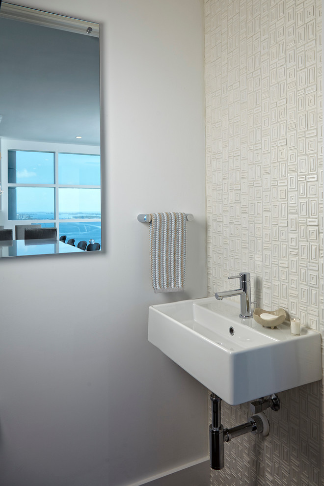 Inspiration for a small transitional white tile and ceramic tile dark wood floor powder room remodel in Miami with a wall-mount toilet, white walls and a wall-mount sink