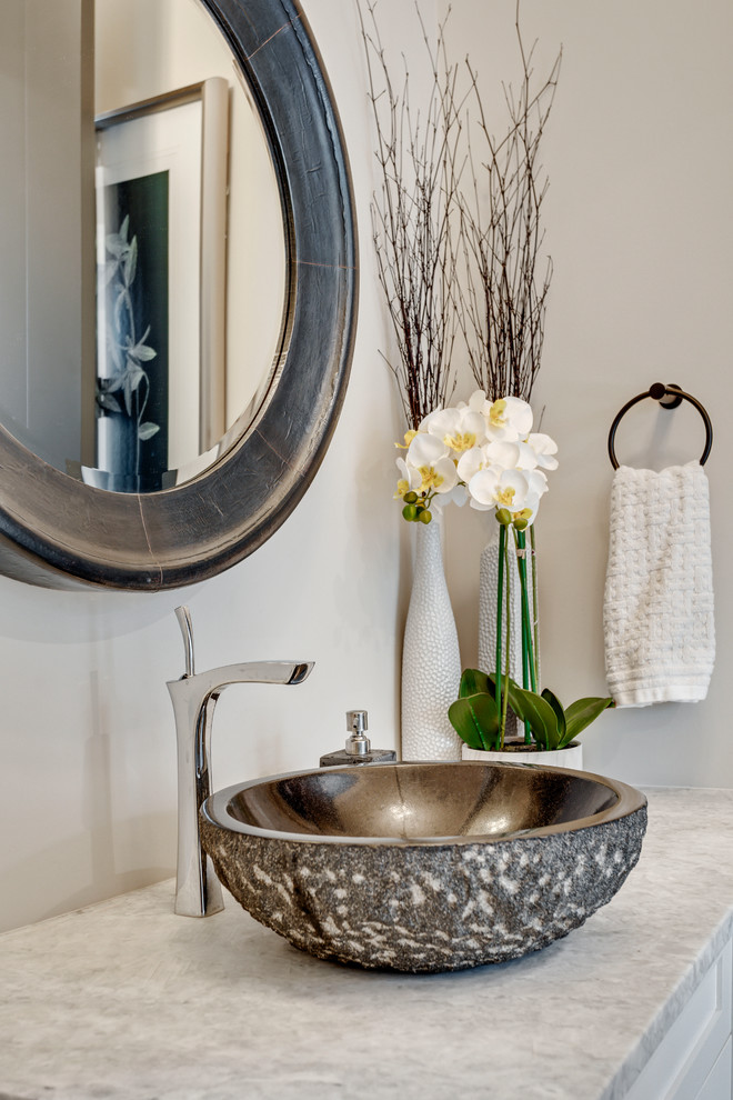 Design ideas for a large traditional cloakroom in Calgary with freestanding cabinets, white cabinets, grey walls, a vessel sink, marble worktops and grey worktops.