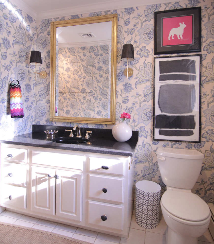Example of a mid-sized eclectic powder room design in New York with raised-panel cabinets, white cabinets, multicolored walls and an undermount sink