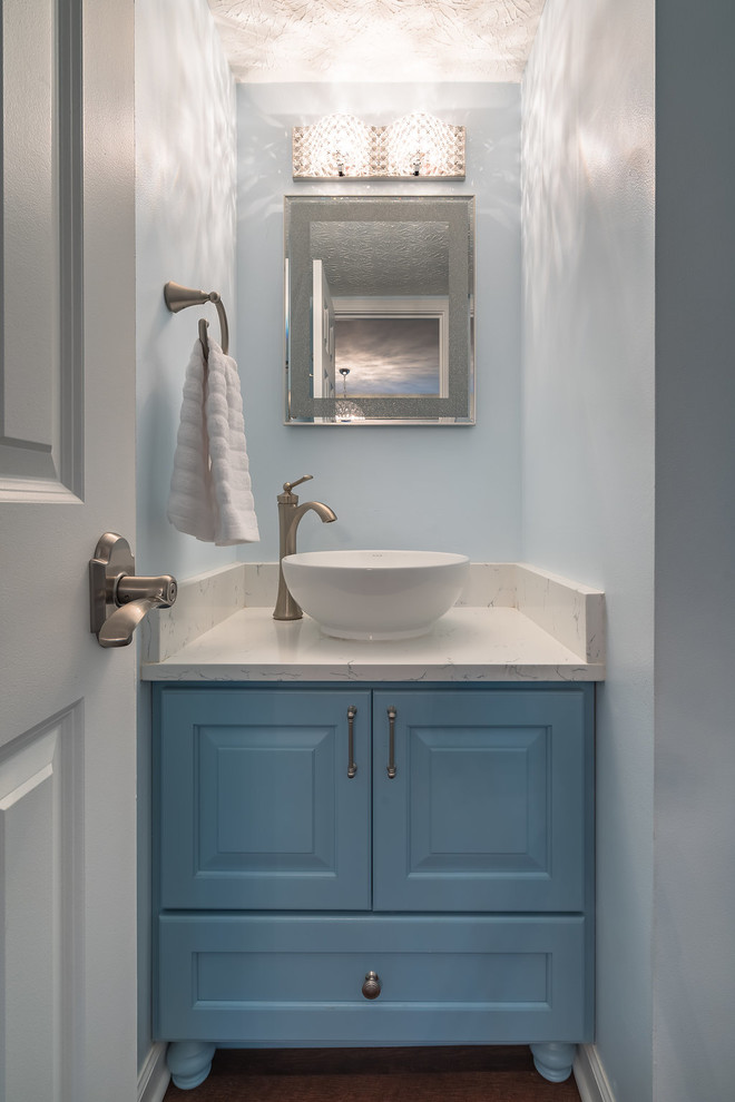 Small transitional vinyl floor and brown floor powder room photo in Columbus with furniture-like cabinets, blue cabinets, blue walls, quartz countertops and white countertops