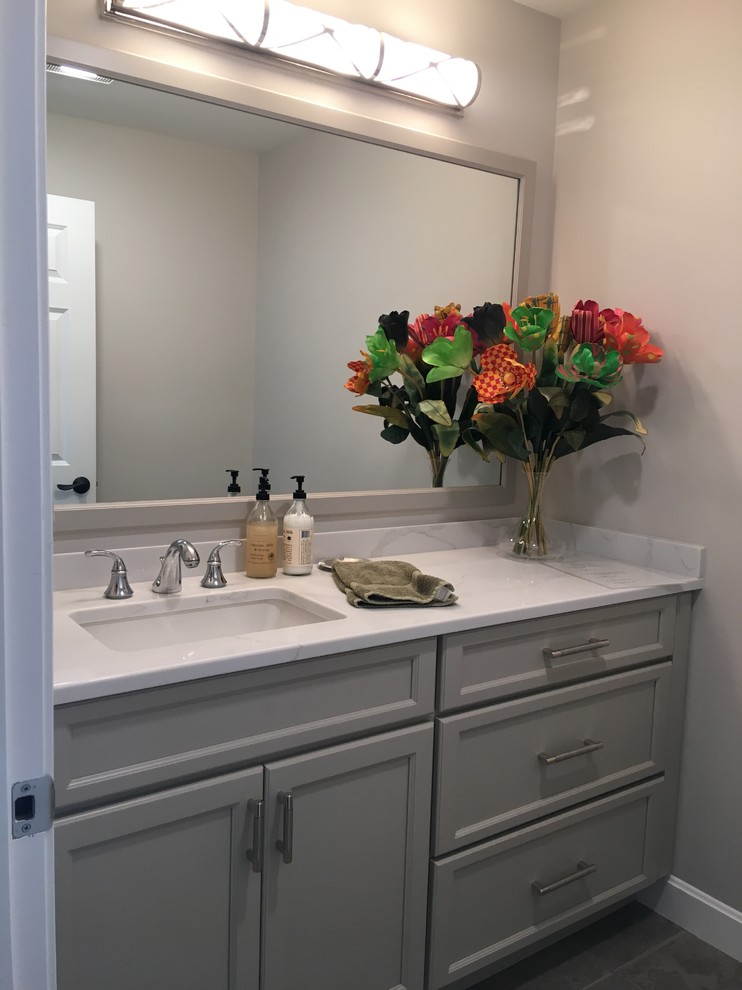 Medium sized classic cloakroom in Portland Maine with shaker cabinets, grey cabinets, grey walls, porcelain flooring, a submerged sink, engineered stone worktops, grey floors and white worktops.