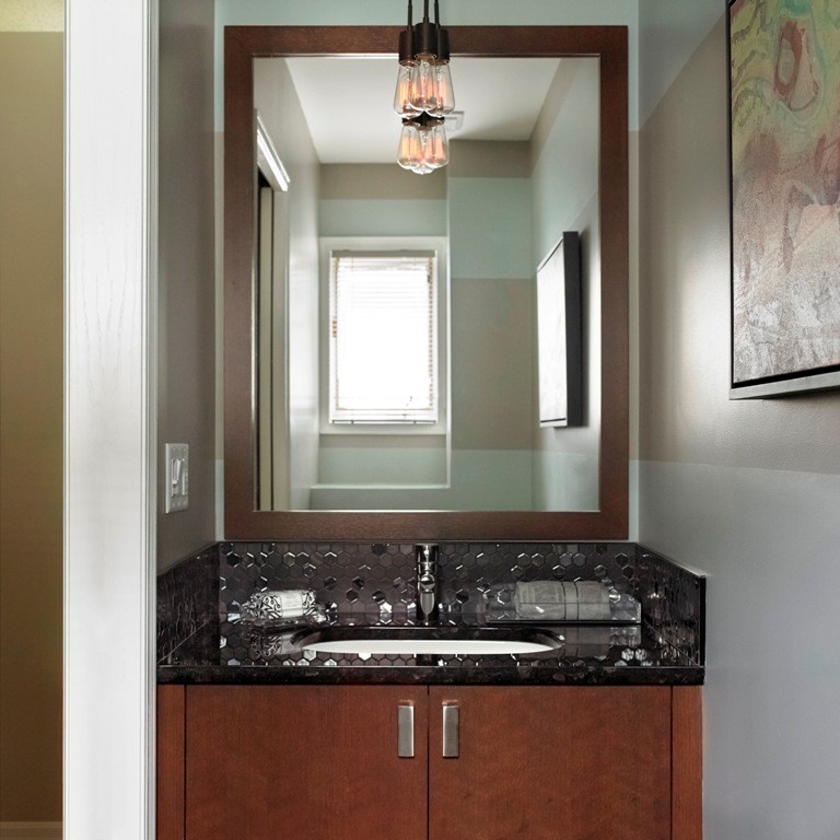 Inspiration for a small classic cloakroom in Calgary with flat-panel cabinets, medium wood cabinets, a two-piece toilet, black tiles, mosaic tiles, multi-coloured walls, porcelain flooring, a submerged sink and granite worktops.