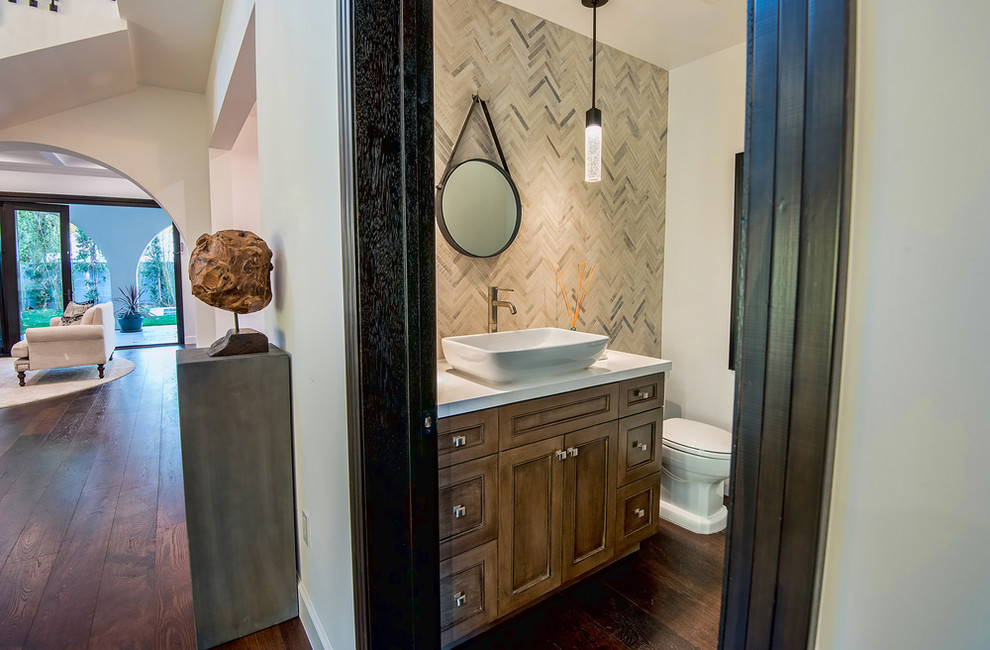 Design ideas for a large mediterranean cloakroom in San Francisco with shaker cabinets, medium wood cabinets, a one-piece toilet, white walls, dark hardwood flooring and a vessel sink.