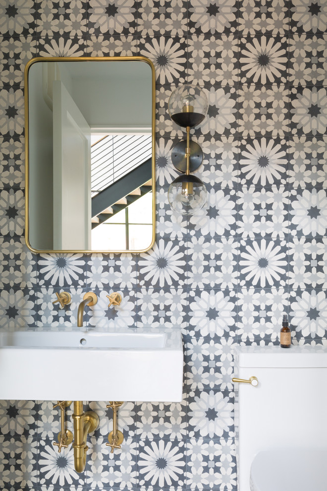 Mid-sized minimalist gray tile and cement tile powder room photo in Austin with open cabinets, white cabinets and solid surface countertops