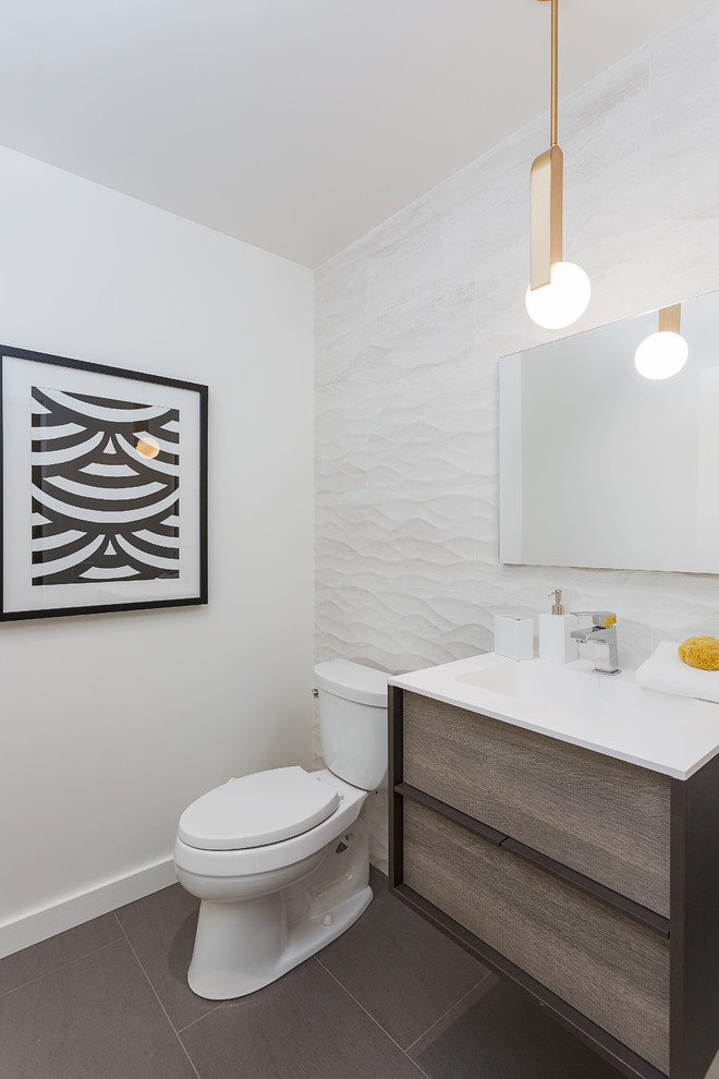Photo of a medium sized contemporary cloakroom in San Francisco with flat-panel cabinets, medium wood cabinets, a one-piece toilet, white walls, porcelain flooring, an integrated sink, engineered stone worktops, brown floors and white worktops.
