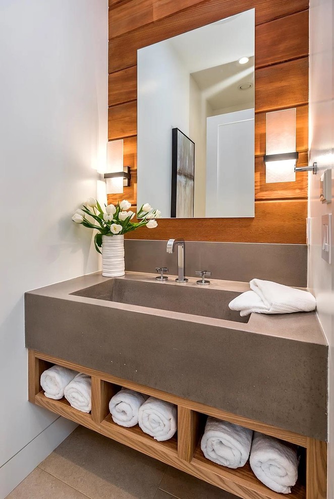 Inspiration for a small modern cloakroom in San Francisco with flat-panel cabinets, medium wood cabinets, a one-piece toilet, white walls, porcelain flooring, an integrated sink, concrete worktops, grey floors and grey worktops.