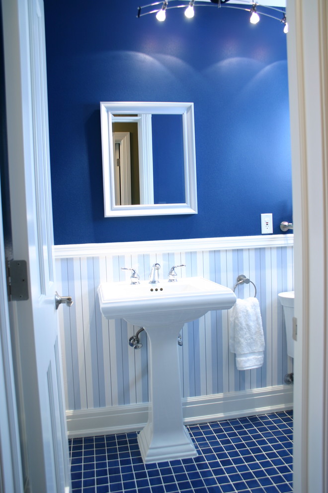 Example of a mid-sized classic blue tile powder room design in Milwaukee with a pedestal sink, a one-piece toilet and blue walls