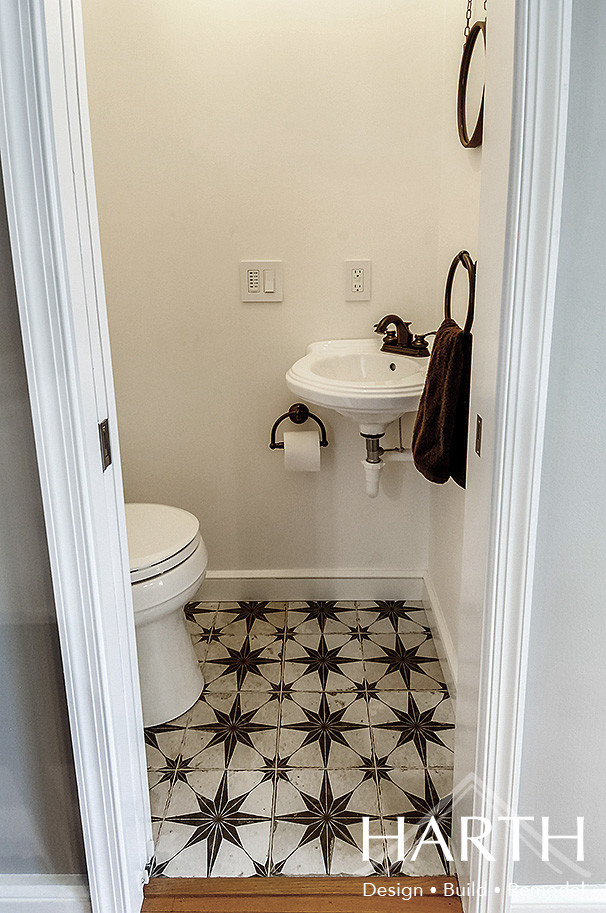 Пример оригинального дизайна: маленький туалет в стиле кантри с раздельным унитазом, белыми стенами, полом из керамогранита, подвесной раковиной и черным полом для на участке и в саду