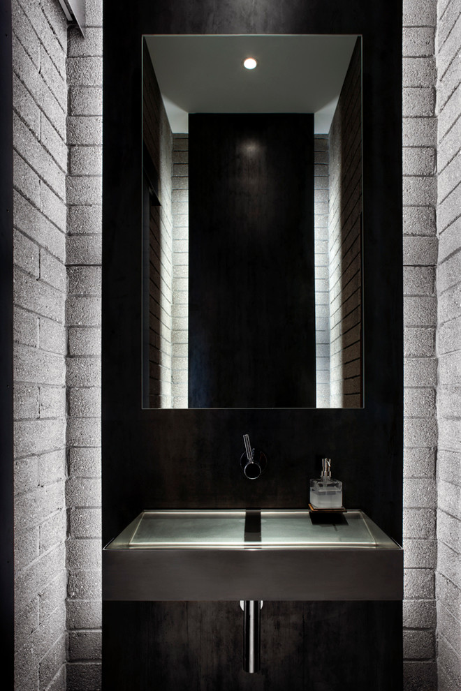 This is an example of a medium sized modern cloakroom in Phoenix with grey cabinets, an integrated sink, stainless steel worktops and grey walls.