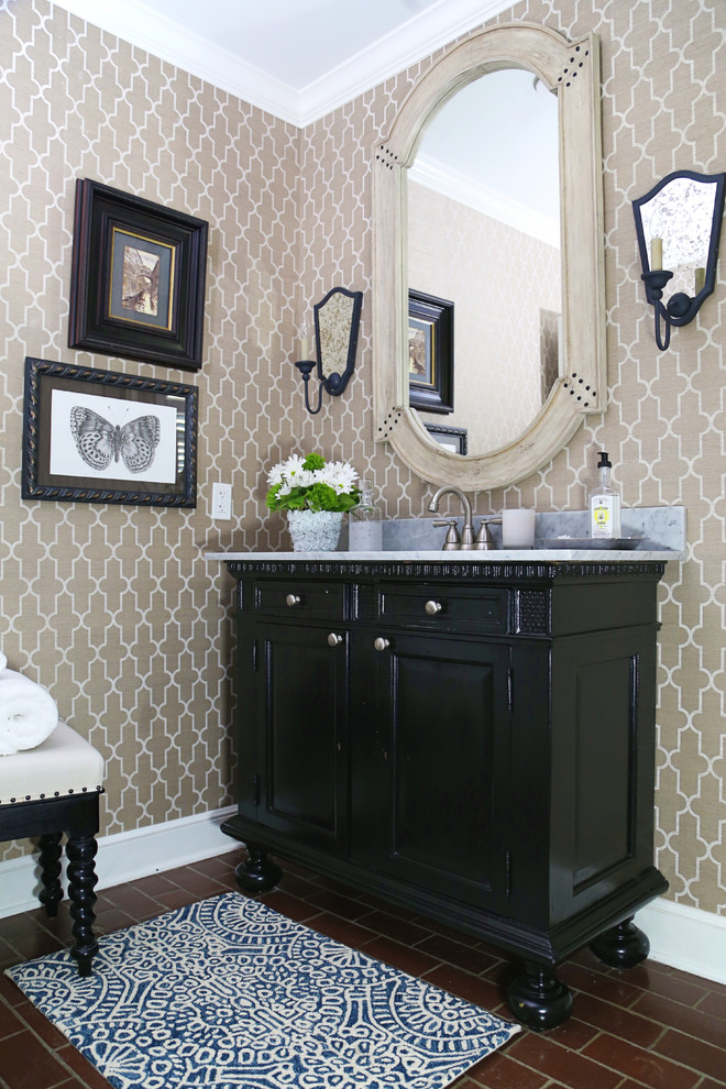 Inspiration for a mid-sized timeless brick floor and red floor powder room remodel in Other with furniture-like cabinets, black cabinets, an undermount sink, marble countertops, a one-piece toilet, beige walls and white countertops