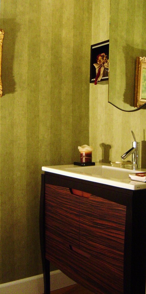 Small trendy powder room photo in Los Angeles with flat-panel cabinets and green walls