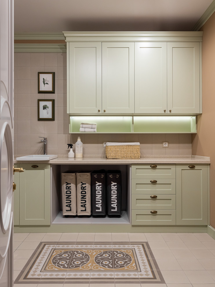 Laundry room - modern laundry room idea in Moscow with green cabinets, beige backsplash, beige walls and beige countertops