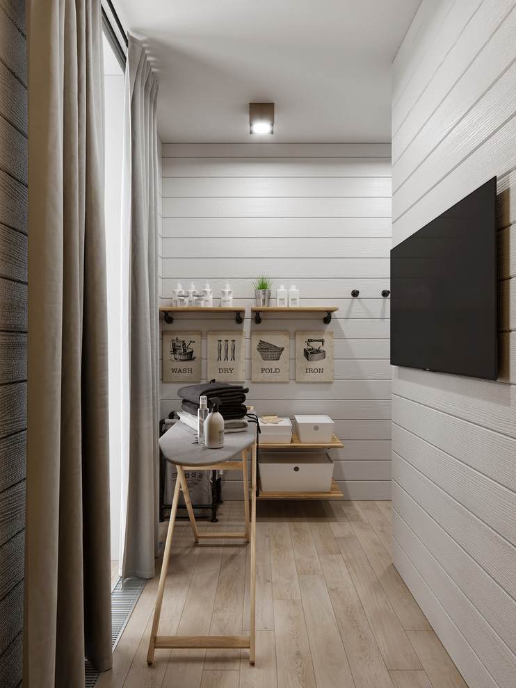 Foto på en liten lantlig tvättstuga enbart för tvätt, med vita väggar, klinkergolv i keramik, tvättmaskin och torktumlare byggt in i ett skåp och beiget golv