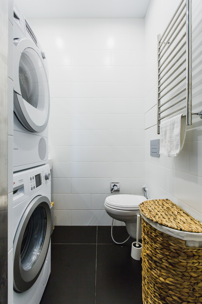 Contemporary utility room in Moscow with a stacked washer and dryer.