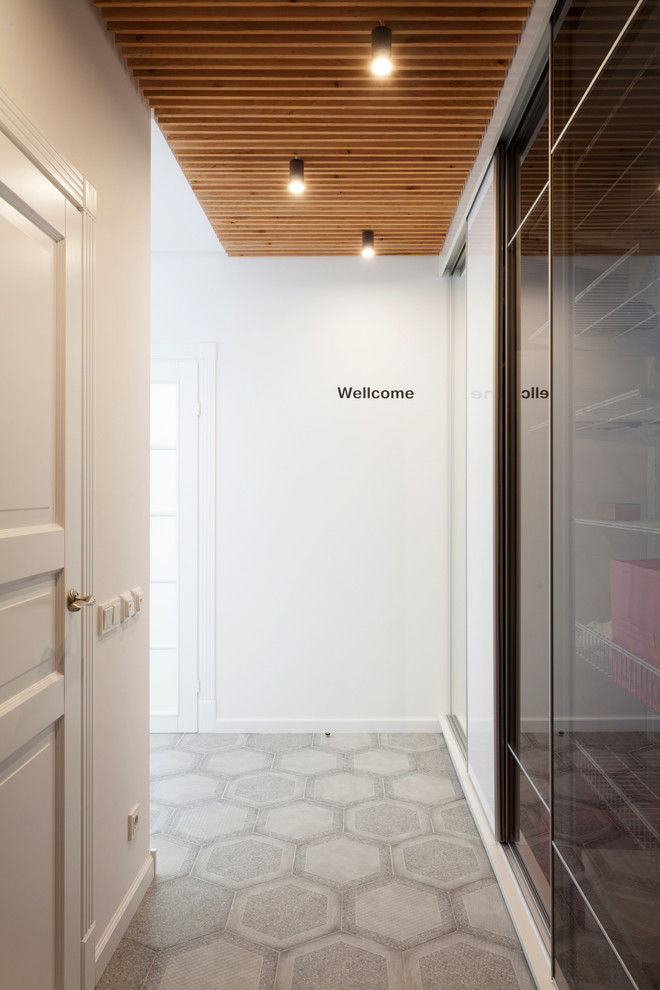 This is an example of a small scandinavian hallway in Other with white walls and ceramic flooring.