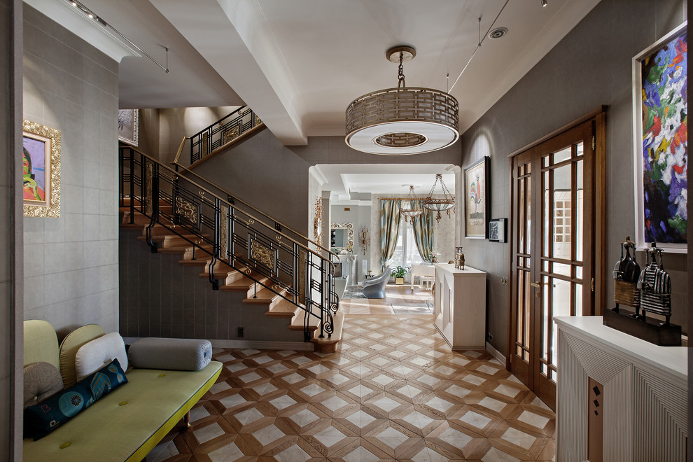 Photo of a large eclectic entrance in Moscow with grey walls and medium hardwood flooring.