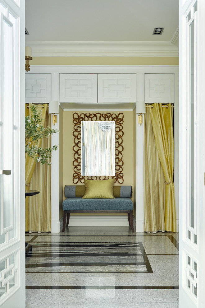 Large classic foyer in Moscow with yellow walls, granite flooring, a double front door and black floors.
