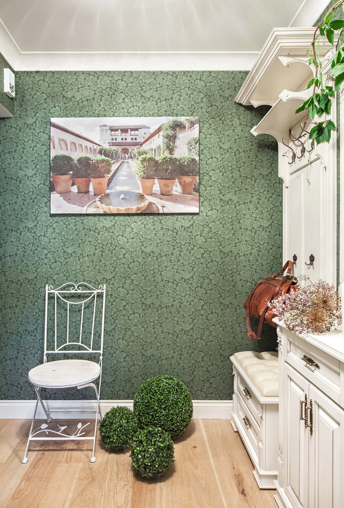 На фото: маленькая прихожая в классическом стиле с зелеными стенами и паркетным полом среднего тона для на участке и в саду с