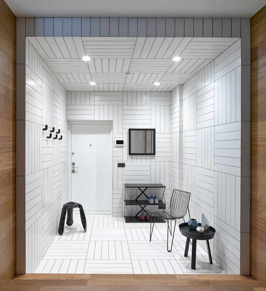 Inspiration pour une porte d'entrée design de taille moyenne avec un mur blanc, un sol en carrelage de céramique, une porte simple, une porte blanche et un sol blanc.