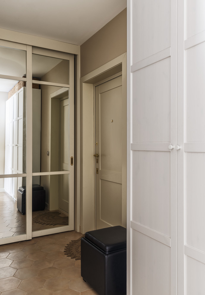 This is an example of a contemporary entrance in Moscow with beige walls, a single front door and brown floors.