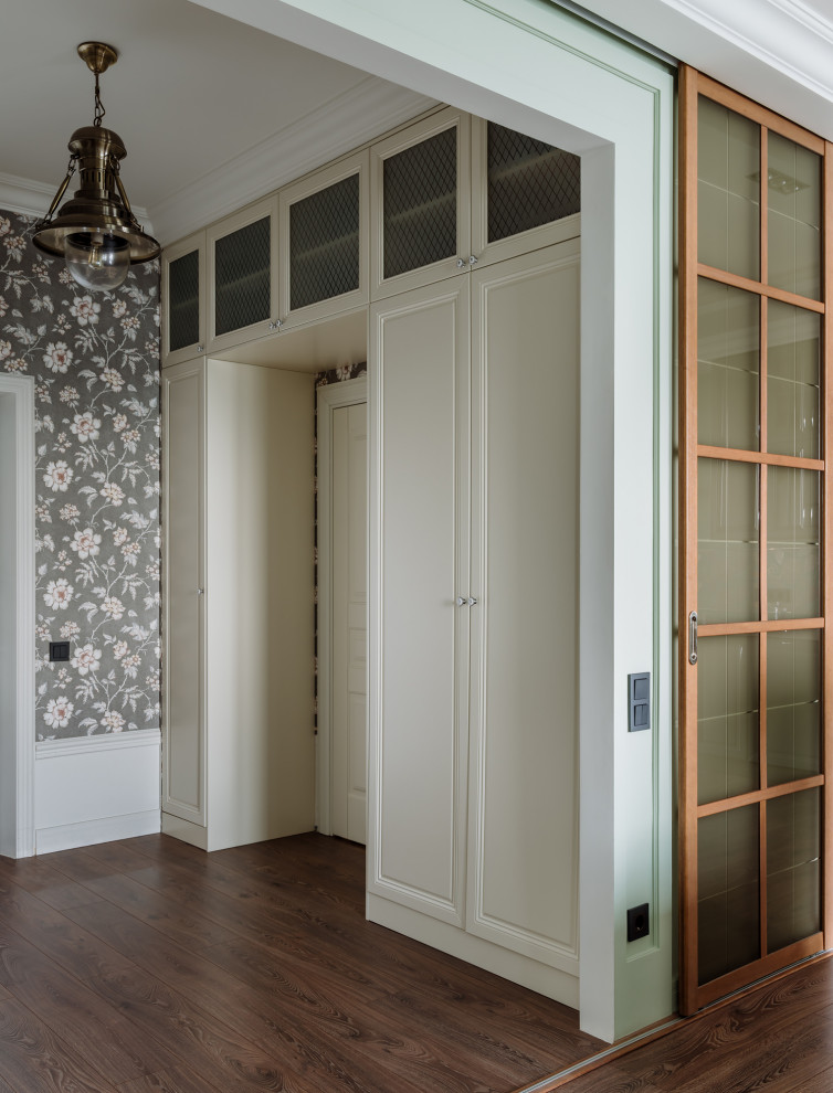 Traditional entrance in Moscow with black walls, dark hardwood flooring, brown floors and wallpapered walls.