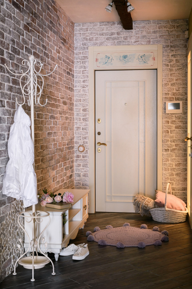 Inspiration for a medium sized vintage hallway in Novosibirsk with brown walls, a single front door, a white front door, brown floors and brick walls.