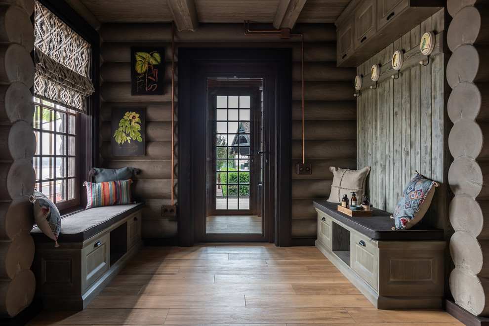 Ejemplo de vestíbulo posterior de estilo de casa de campo grande con paredes grises, puerta simple, puerta de vidrio, suelo beige y suelo de madera en tonos medios