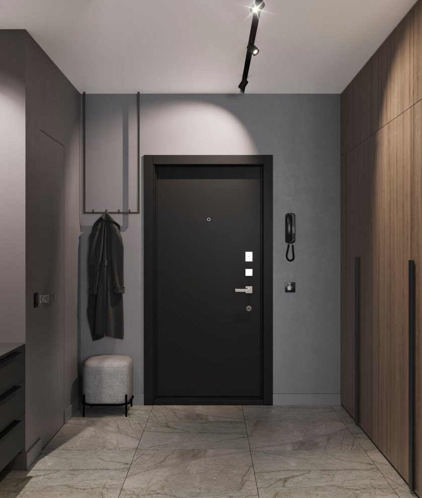 Aménagement d'une petite entrée contemporaine avec un couloir, un mur gris, un sol en carrelage de porcelaine, une porte simple, une porte noire et un sol gris.
