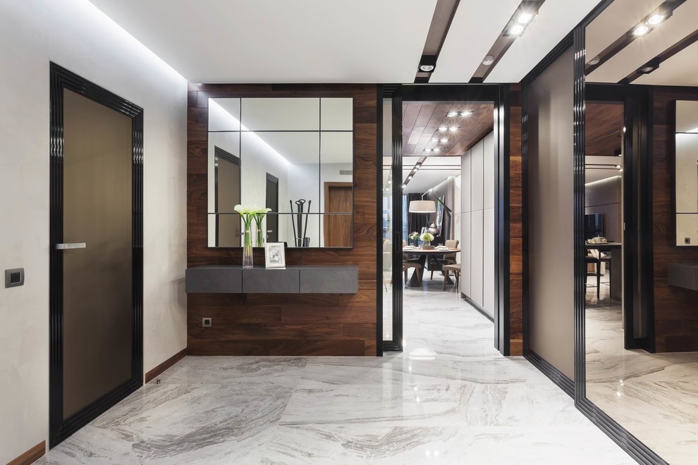 This is an example of a contemporary entrance in Other with white walls and grey floors.
