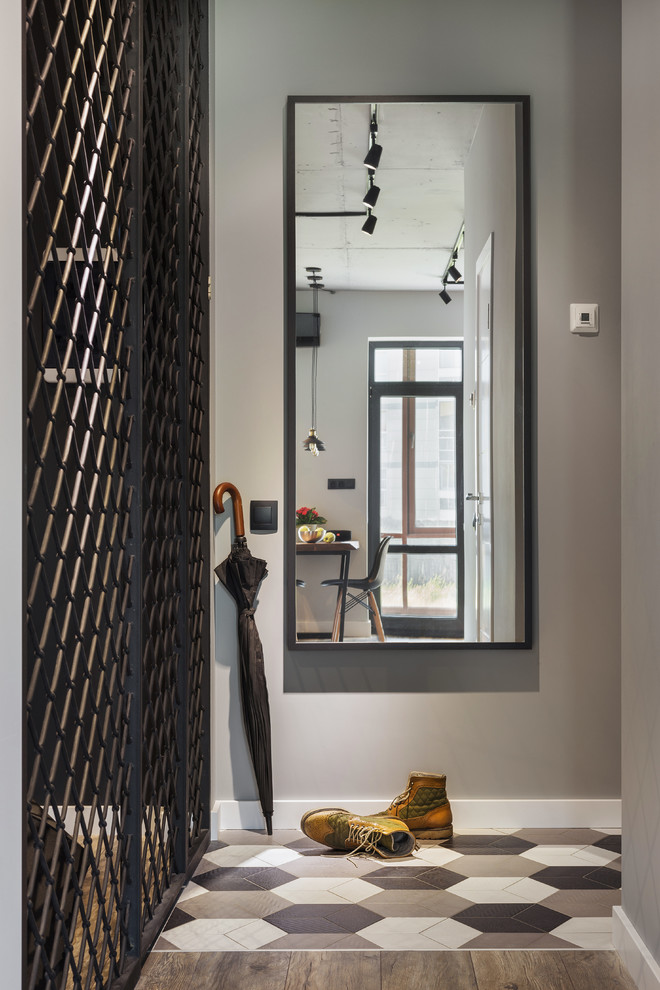 Small urban ceramic tile and multicolored floor entry hall photo in Moscow with gray walls