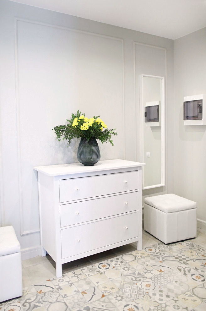 This is an example of a large contemporary hallway in Saint Petersburg with porcelain flooring, multi-coloured floors and grey walls.