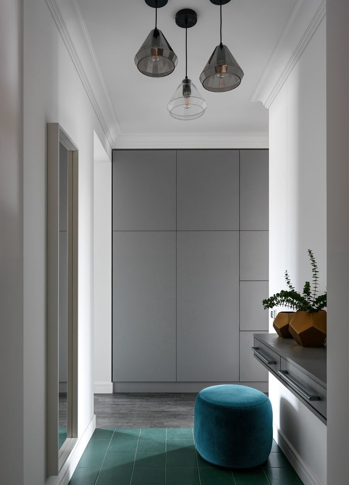 Medium sized contemporary entrance in Moscow with white walls and green floors.