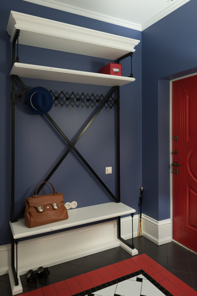 Ispirazione per un ingresso o corridoio classico con pareti blu, una porta singola, una porta rossa e pavimento multicolore