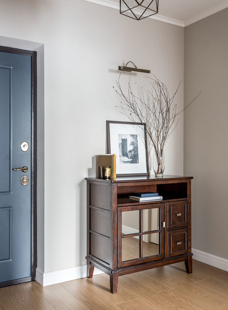 Transitional medium tone wood floor and beige floor entryway photo in Moscow with gray walls and a blue front door