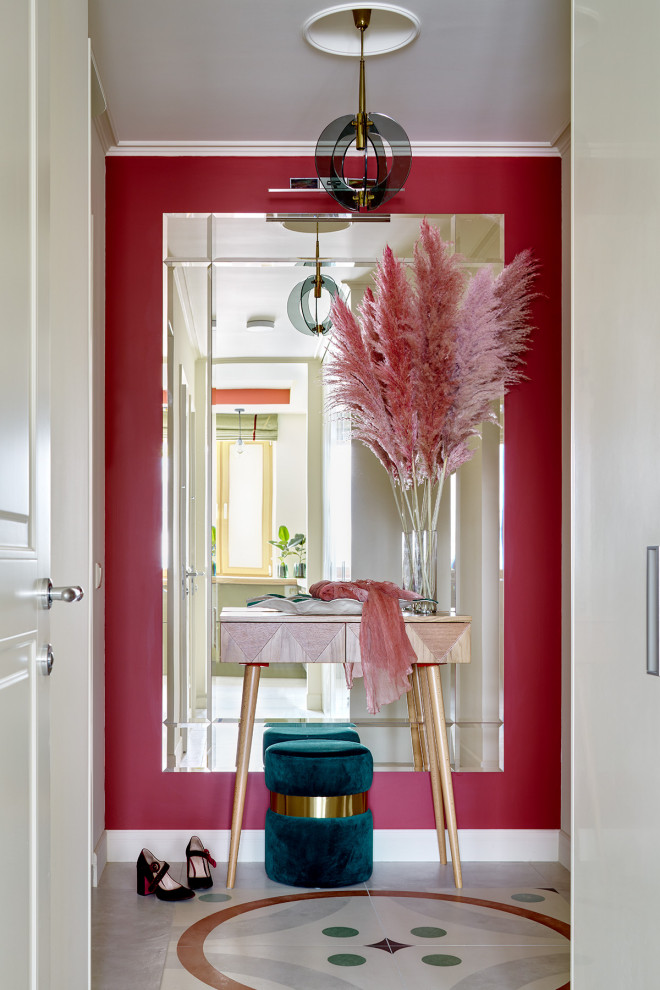 Cette photo montre une entrée tendance de taille moyenne avec un couloir, un sol en carrelage de porcelaine, une porte simple, une porte blanche, un sol multicolore et un mur rouge.